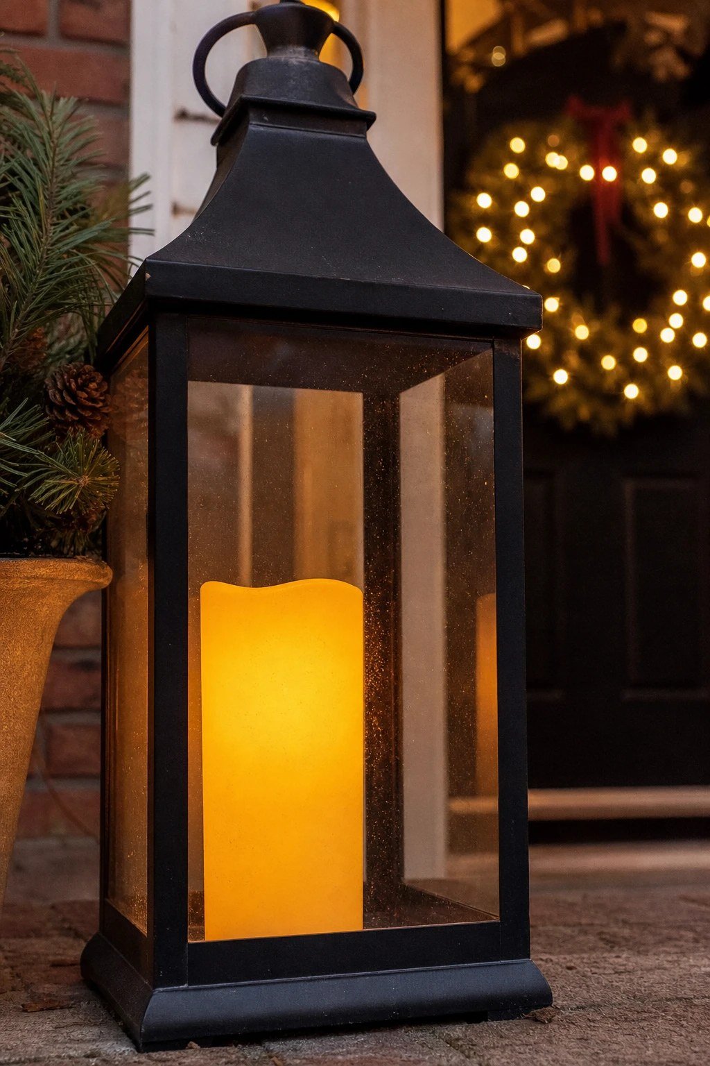 Front door Christmas decoration idea: timer candles in the windows and lanterns