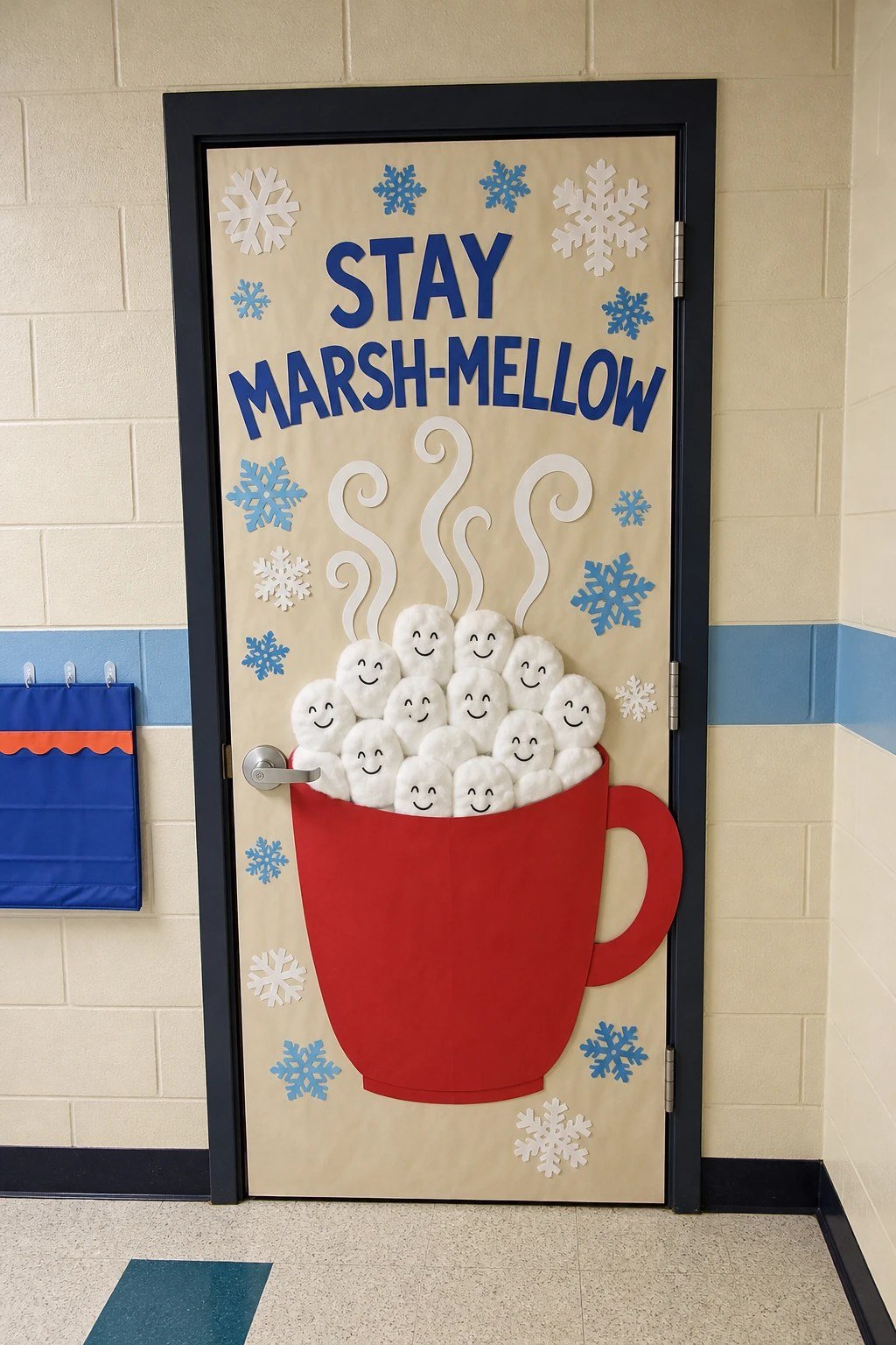 A classroom door with a giant paper cocoa mug and smiling marshmallows
