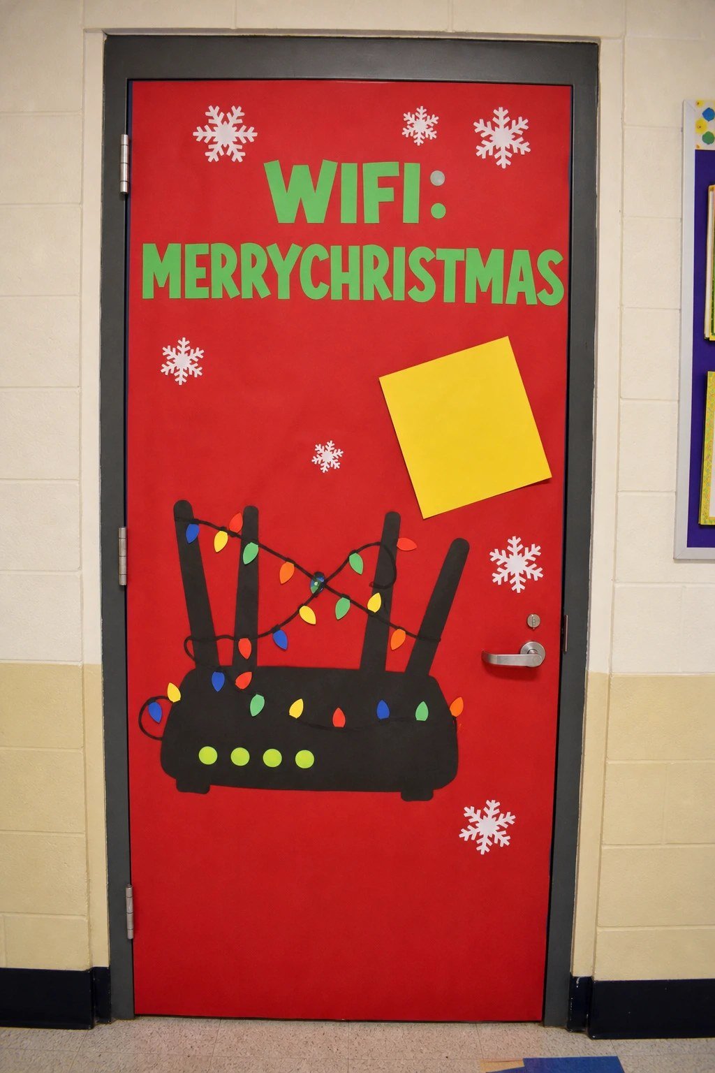 A classroom door with a paper WiFi router wrapped in lights