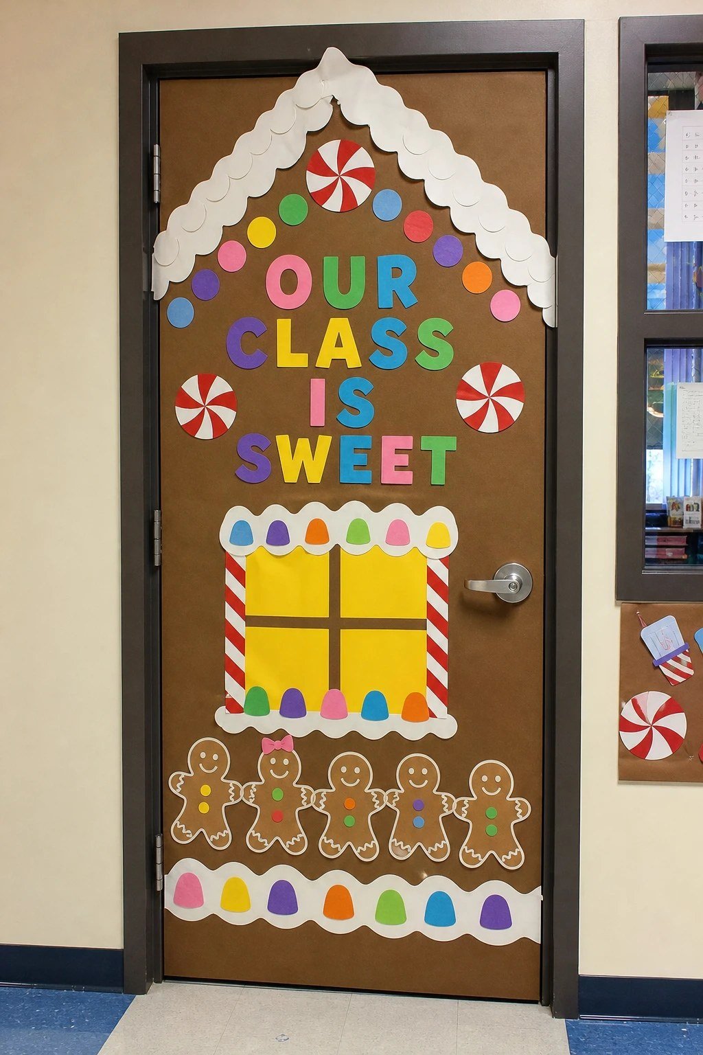 A classroom door decorated as a gingerbread house with an Our Class Is Sweet banner