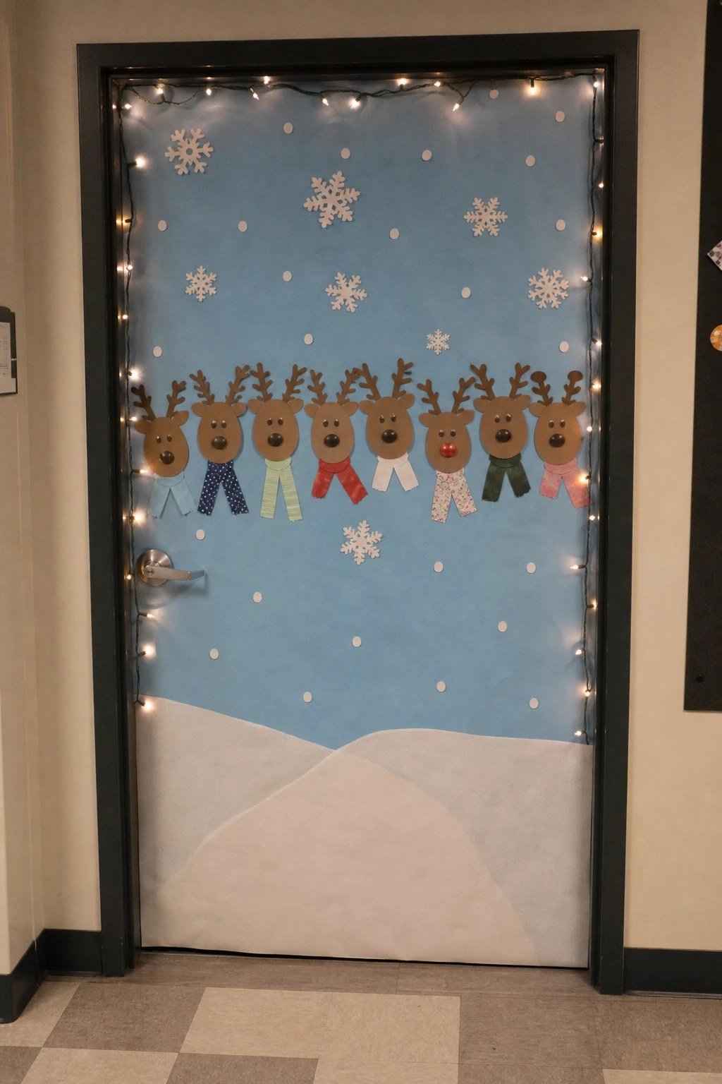 An office door decorated with a row of paper reindeer faces
