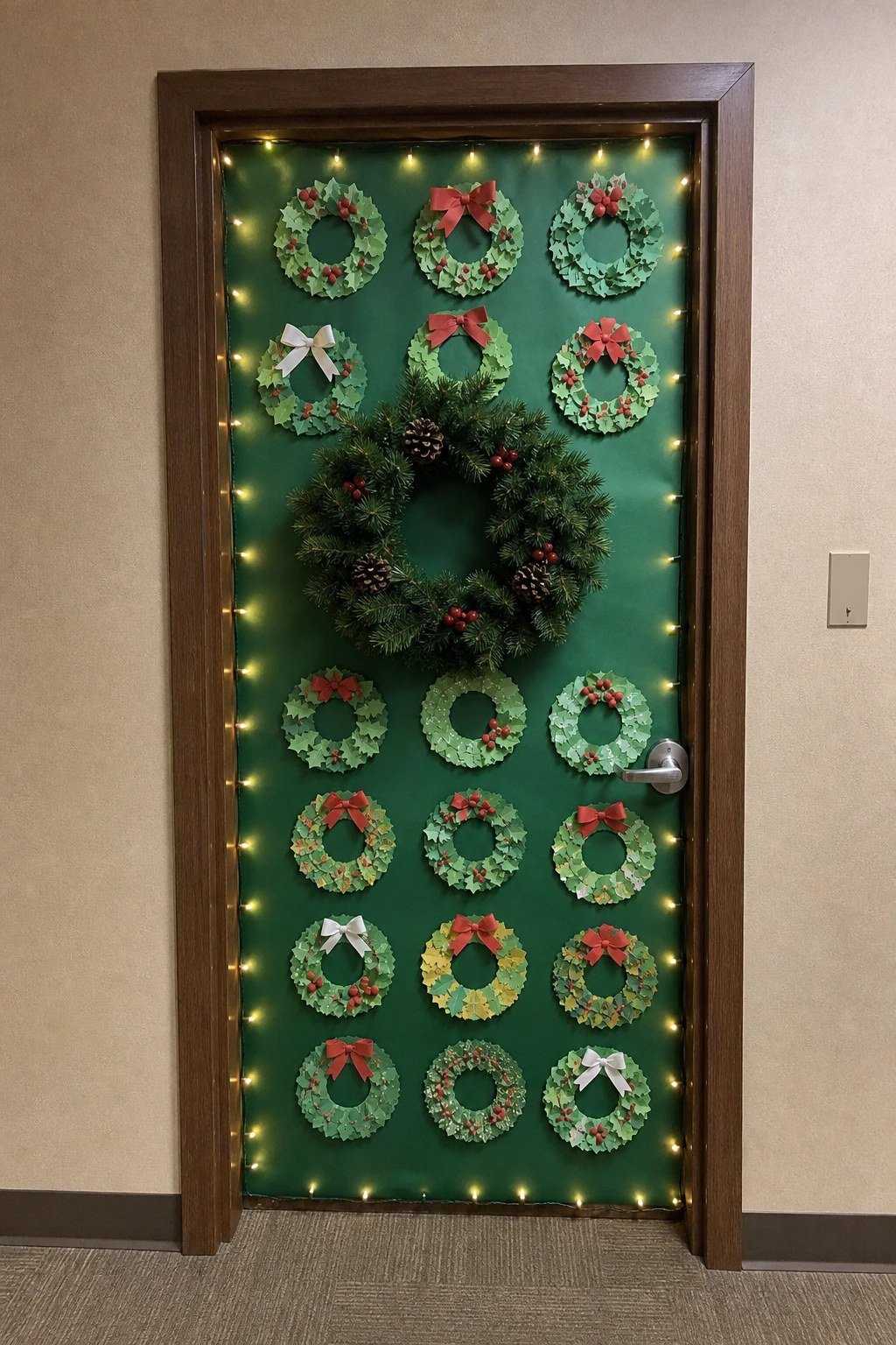 An office door covered in rows of small handmade paper wreaths